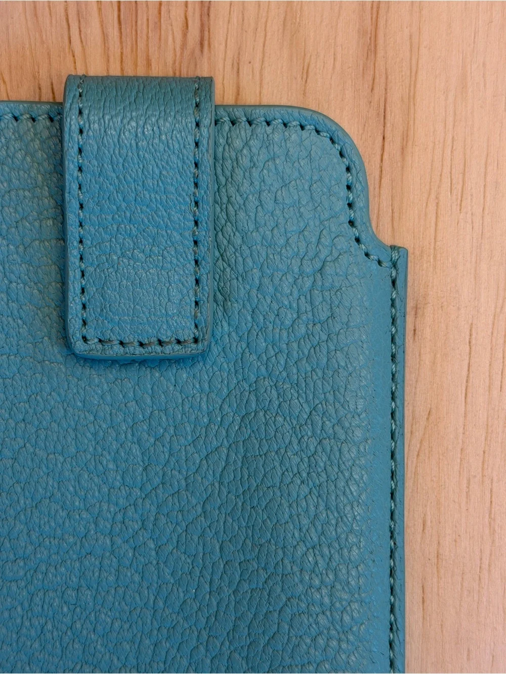 Tiffany & Co. turquoise pebbled leather phone sleeve with gold logo